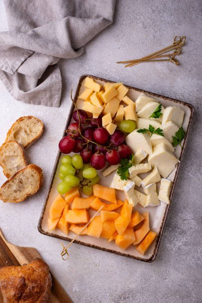 istock Cheese plate with different cheese, grapes and melon. 2164713080