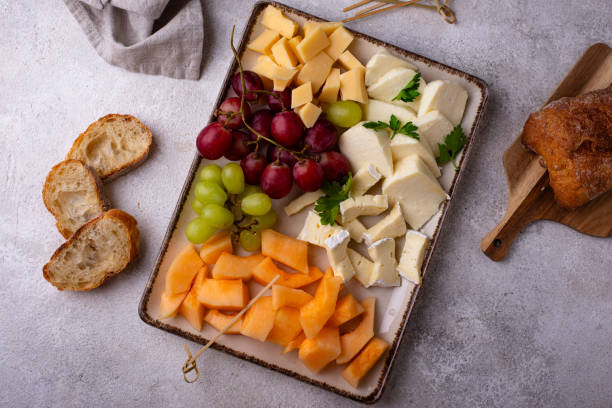 istock Cheese plate with different cheese, grapes and melon. 2164713083