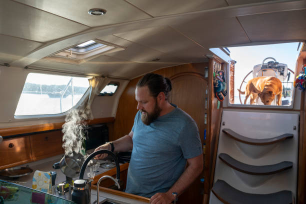 istock Man prepares meal in sailboat kitchen 2164713701