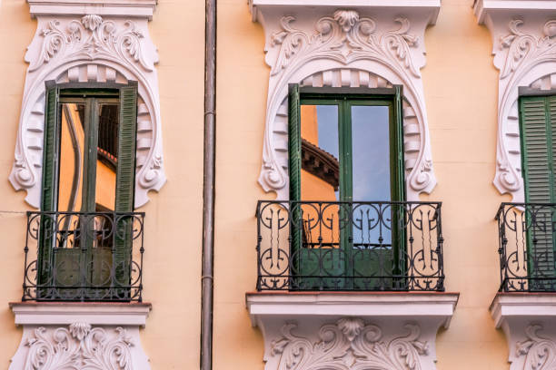 Madrid, Spain - January 10, 2020: Typical building facade of Madrid architecture, with its colors, windows and balconies