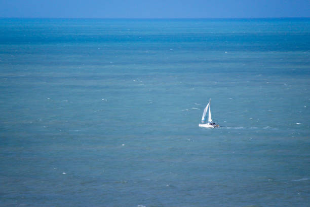 Sailboat sailing on blue ocean. Atlantic ocean, Natal, Rio Grande do Norte.