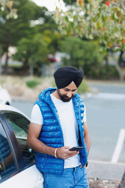 istock Indian man using phone - looking at phone 2164723227