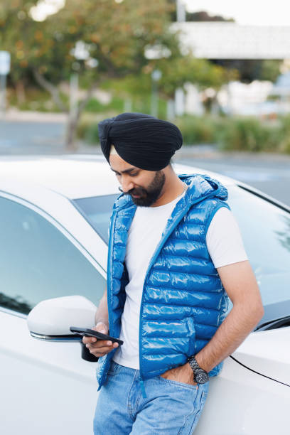 istock Indian man using phone - looking at phone 2164723240