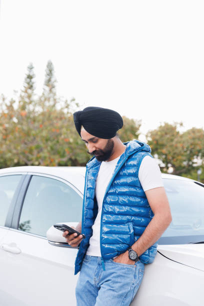 istock Indian man using phone - looking at phone 2164723241