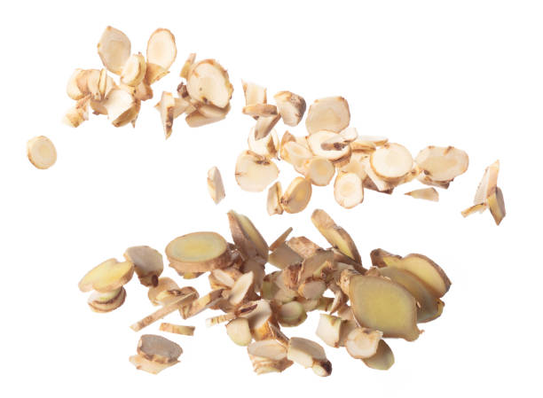 istock Organic fresh herbal galangal root head cut chop slice, close up texture. White background isolated freeze motion high speed shutter. Galangal fly in mid air, fresh vegetable spice galangal falling 2164724078