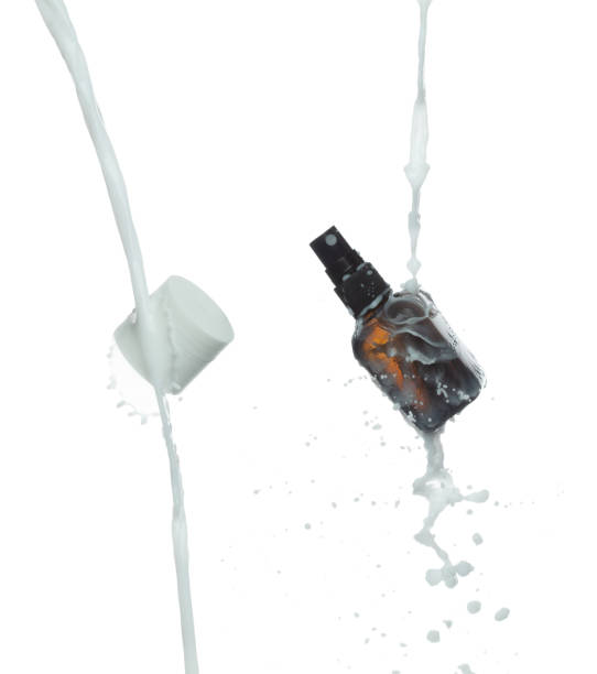 istock Milk lotion pour float to cosmetic bottle. Moisturizer lotion explosion spill. White background isolated high speed shutter freeze. Cosmetic container white lotion droplet shape form fly splashing 2164724081