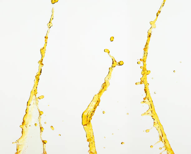 istock Fruit beverage water elements in line form . Fresh splashing and flowing jets, white background isolated freeze motion. Orange, lemon juice or oil lubricant splash, liquid gold yellow drink drops 2164724082