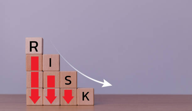 istock Risk wording on decreasing coins stacking with down arrow for financial banking risk analysis and management, Risk and a down arrow. Reduce financial risk for investment and capital. 2164726260