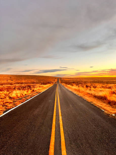 istock New Mexico desert empty two lane road with solid lines at golden hour 2164727341