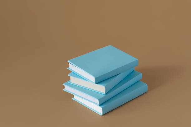 istock Stack of blue books on a brown background with soft shadow, copy space. Book Lovers Day concept 2164731752