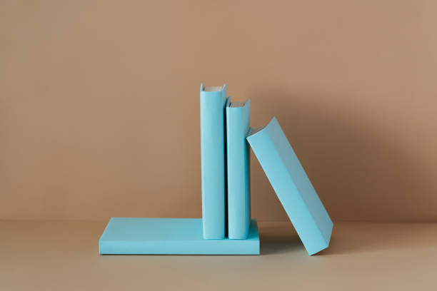 Composition of blue books on a brown background with soft shadow, copy space. Study, education and Book Lovers Day concept