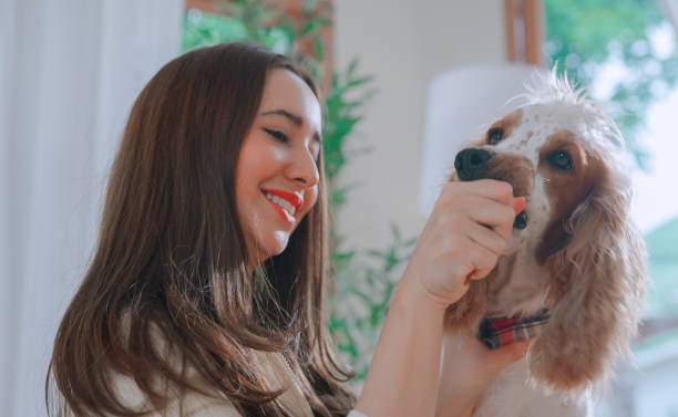 istock Young woman playing with her dog 2164733762