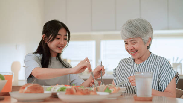 istock Mother and daughter having meal together 2164734047