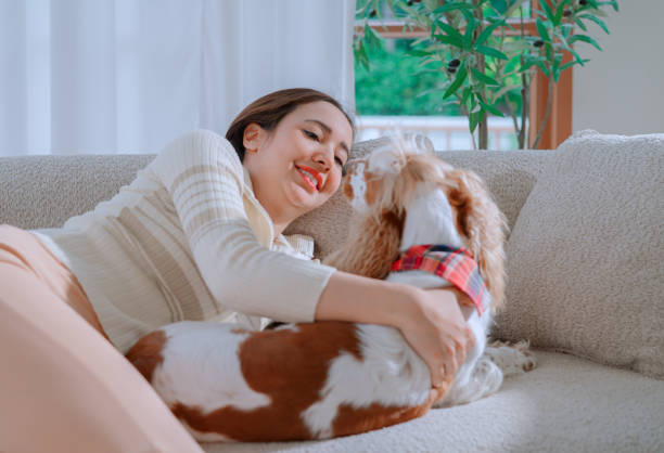 istock Young woman playing with her dog 2164734101
