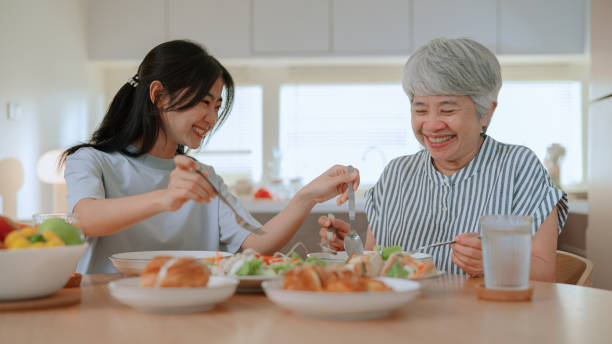 istock Mother and daughter having meal together 2164734274