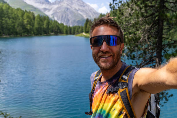 istock Man Taking Selfie by Mountain Lake 2164735151