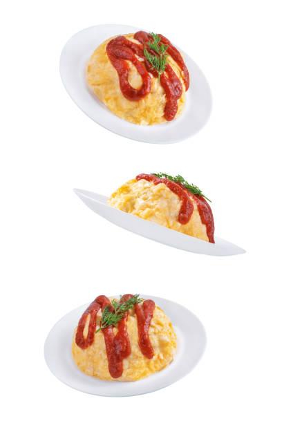 Omurice with ketchup sauce in a plate on a white isolated background