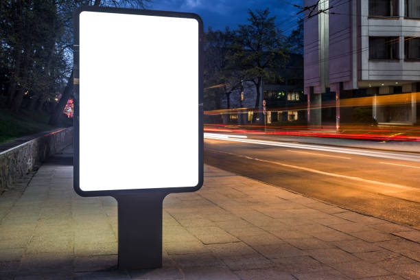 istock Blank White Mockup Of Vertical Poster Billboard With Car Light Trails At Night 2164739131