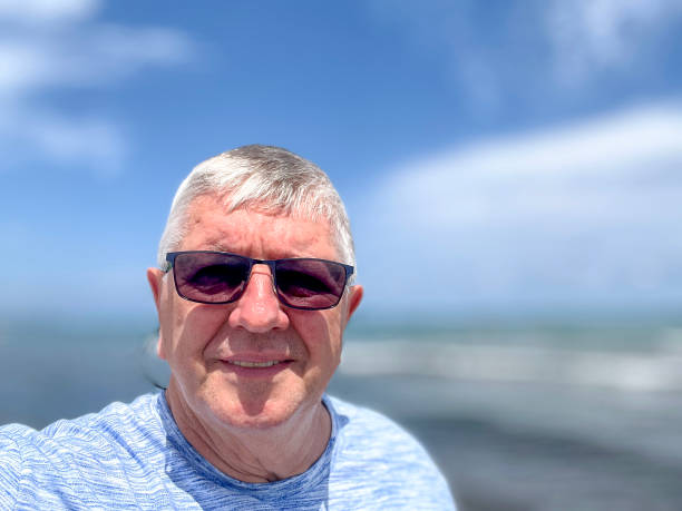 istock Senior Caucasian man selfie outdoors at beach 2164741338