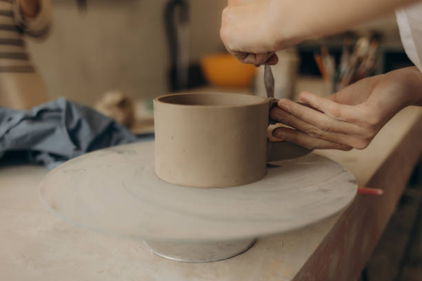 istock Female master paints a pot, pottery workshop 2164743637