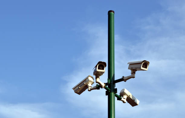 istock surround security cctv camera on green steel post and blue sky with copy space 2164746455