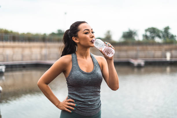 istock fitness woman drinking water 2164746549