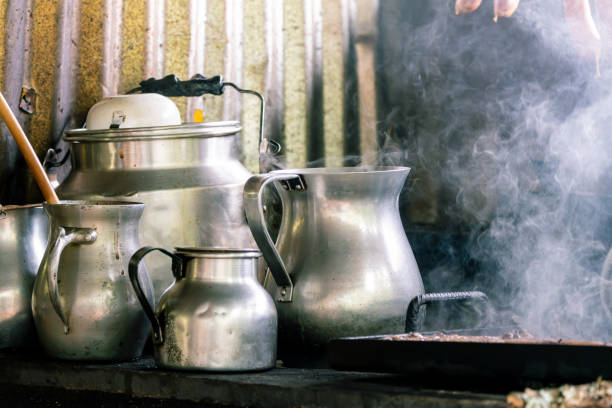 istock Rustic kitchen scene with steaming metal jugs and kettles on a stove 2164746732