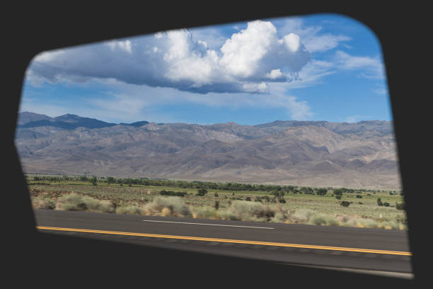 View of the Owens valley mountain landscape from the window of a car on the road.