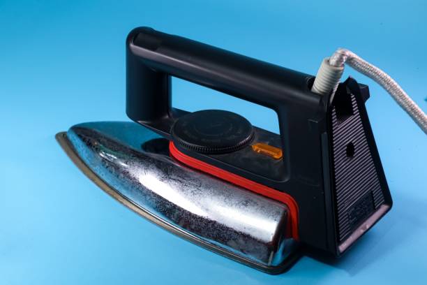 istock electric iron rear view on blue background 2164748093