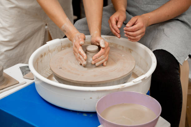 istock Ceramics workshop. Modeling a shape of your own clay project. Improving skills in traditional pottery. Learning how to create a bowl using a pottery wheel. 2164748272