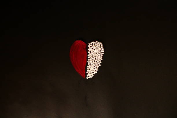 A view of heart shape that is half filled with homoeopathic pills. Homoeopathy concept photography. Homoeopathy heals.