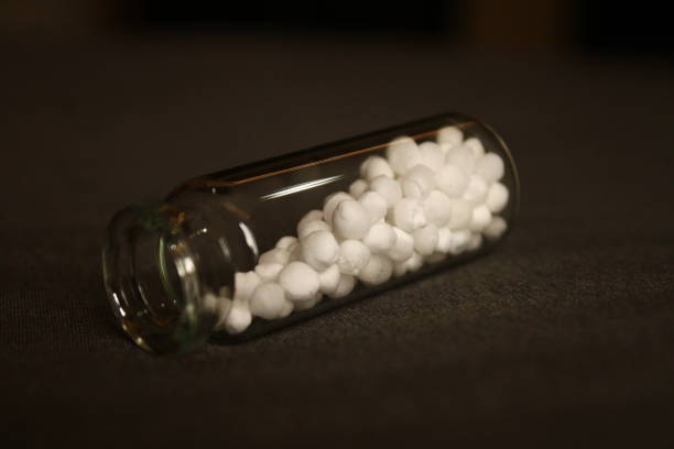 istock Glass bottle and homoeopathic pills. 2164752129