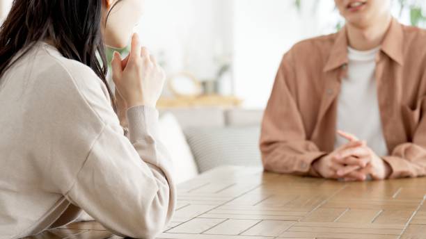 Couple having a serious conversation in the living room stock photo