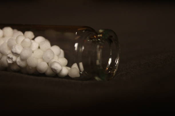 istock Glass bottle and homoeopathic pills. 2164753068