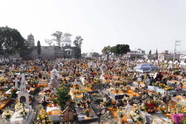 A decorated graveyard during day of the dead in Mexico. Concept of traditional Dia de Muertos celebration