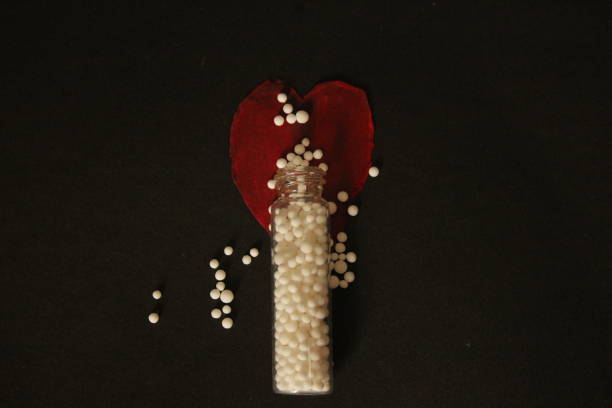 Homoeopathy healthcare and medicine. Conceptual photography for homoeopathy. Glass container with homoeopathic pills. Homoeopathy as an alternative medicine. rajkot india stock pictures, royalty-free photos & images