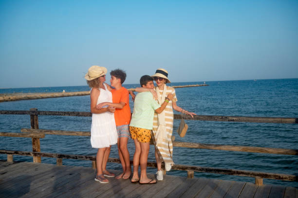 istock Family hugging and laughing on a pier 2164764464
