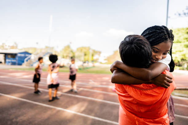 istock Athlete embracing instructor on a running track 2164766894