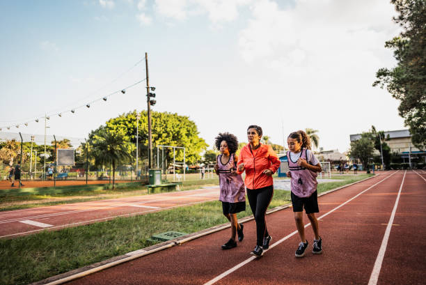 istock Instructor and athletes running on a running track 2164767894