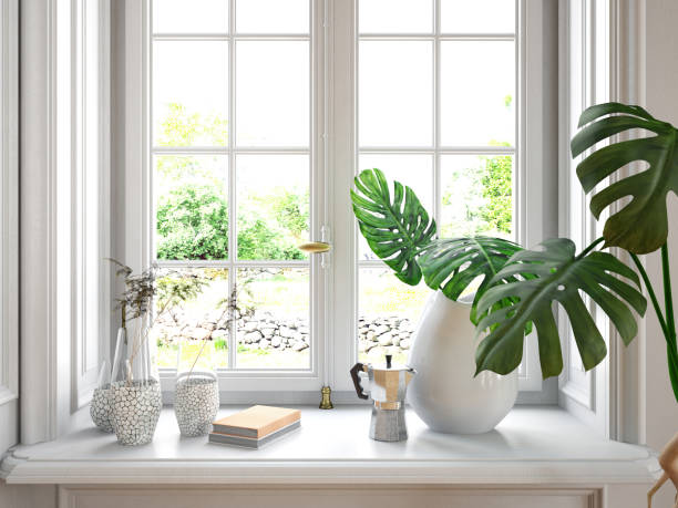 White geranium flowers (Pelargonium) planted in pots placed on a white windowsill. The window opens up to a lush summer garden with sunlight and greenery, creating a serene and natural ambiance.