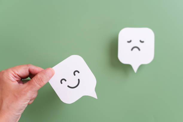istock hand choose smile face icon on real speech bubble paper cut, for recruitment, good feedback rating, positive thinking, customer review, assessment, mental health concept 2164769706