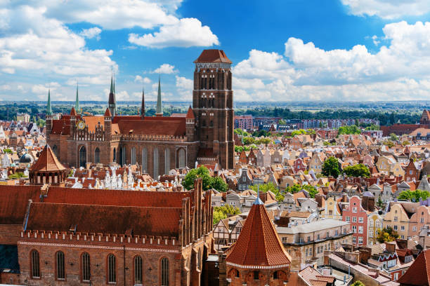 Panoramic View of St. Mary's Basilica and Historic Old Town Architecture with Red Tiled Roofs in Gdańsk. stock photo