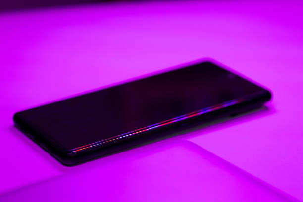 black smartphone screen in purple neon lights
