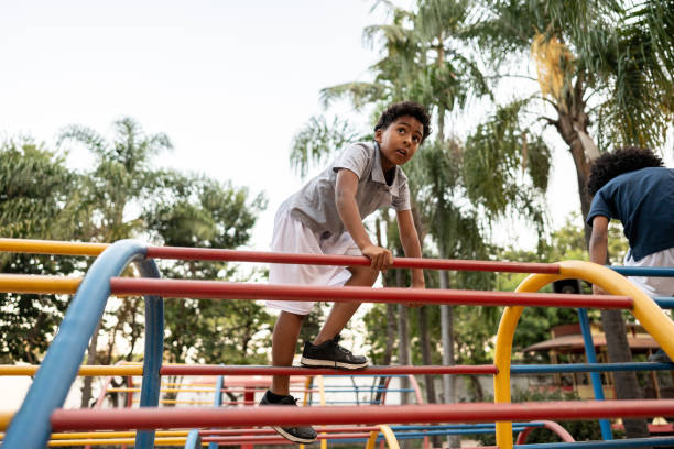 istock Boy playing on jungle gym on a playground 2164772641