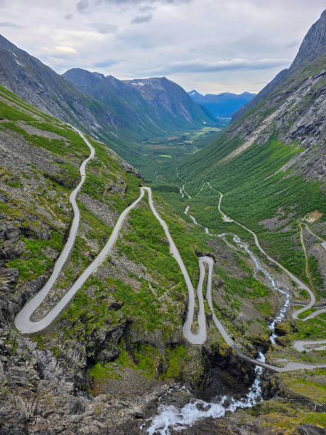 istock Winding Mountain Road Through Lush Valleys in Norway on a Cloudy Day 2164773301