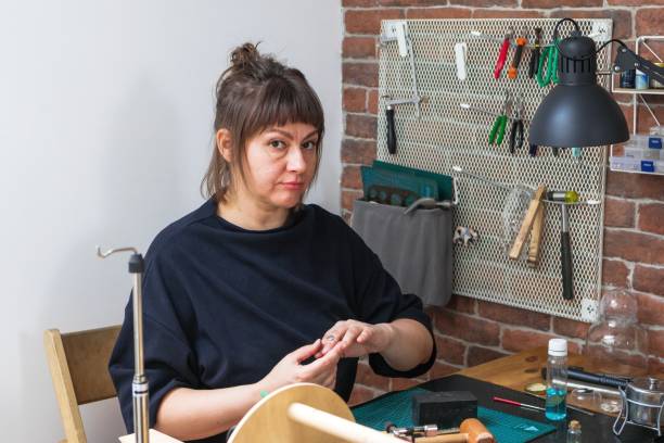 istock Craftswoman creating a ring in her cozy studio, with tools, materials, and creativity. 2164773662