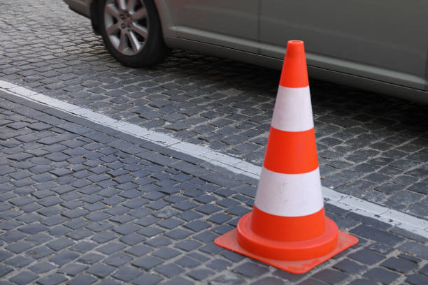 istock Traffic cone on the road with car 2164775246