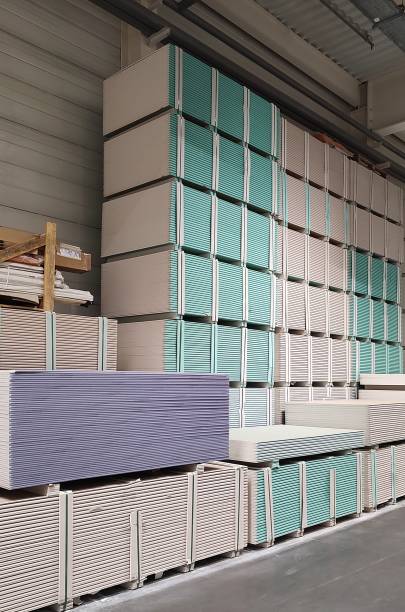 istock Warehouse with gypsum plasterboard sheets stacked on pallets. 2164775302