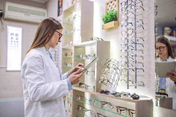 istock Optician with tablet in modern eyewear store overview 2164775580
