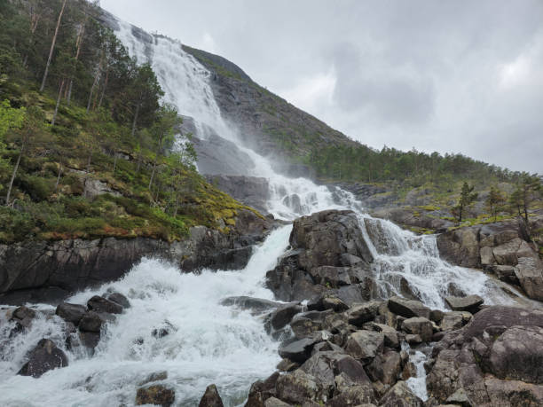 istock Majestic Waterfall Cascading Down Rugged Cliffs in Norway's Enchanting Landscape 2164776030